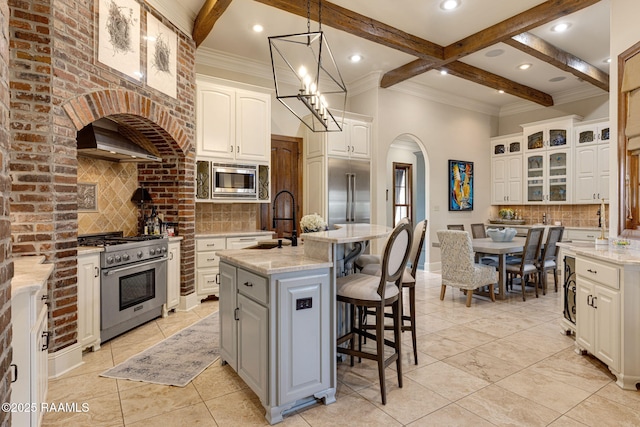 101 Enclave Ct, Lafayette, LA 70508 - kitchen featuring built in appliances, tasteful backsplash, beamed ceiling, light tile patterned floors, and recessed lighting