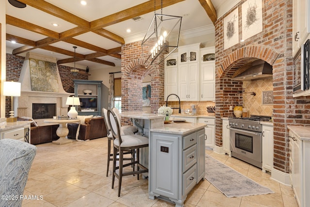 101 Enclave Ct, Lafayette, LA 70508 - kitchen featuring high end range, a fireplace, gray cabinetry, decorative backsplash, and open floor plan