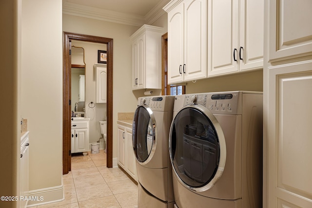 101 Enclave Ct, Lafayette, LA 70508 - laundry area with cabinet space, washer and dryer, light tile patterned flooring, and crown molding