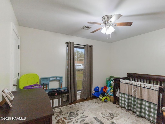 1166 Madeline Hts, Breaux Bridge, LA 70517 - bedroom with a crib, ceiling fan, and wood finished floors