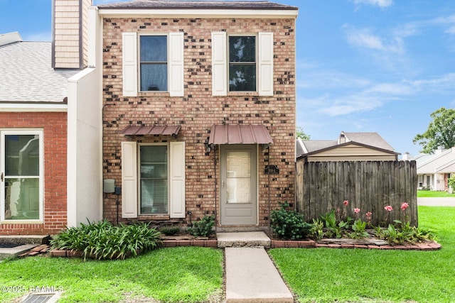 209 Long Plantation Unit A, Lafayette, LA 70508 - view of front of property featuring brick siding, a shingled roof, and a chimney