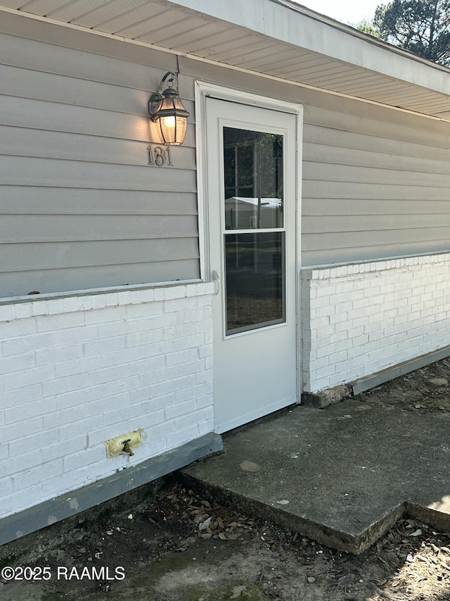 131 Justin St, Lafayette, LA 70501 - doorway to property featuring brick siding