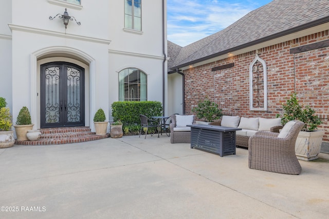 506 Terrell Ct, New Iberia, LA 70563 - entrance to property with an outdoor hangout area, stucco siding, roof with shingles, brick siding, and a patio