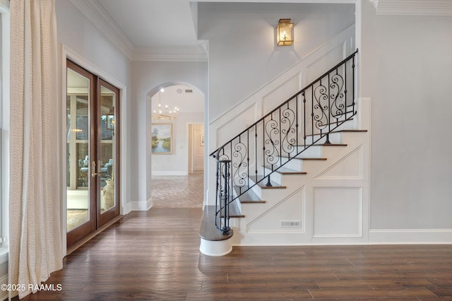 506 Terrell Ct, New Iberia, LA 70563 - foyer entrance with ornamental molding, wood finished floors, arched walkways, and stairs