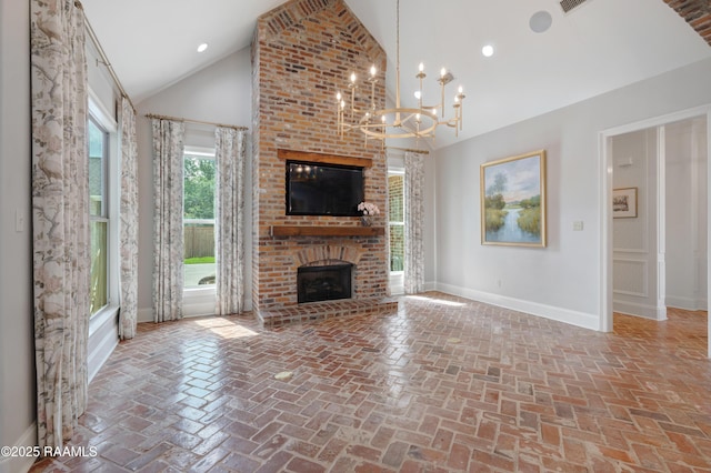 506 Terrell Ct, New Iberia, LA 70563 - unfurnished living room featuring a brick fireplace, a chandelier, brick flooring, and high vaulted ceiling