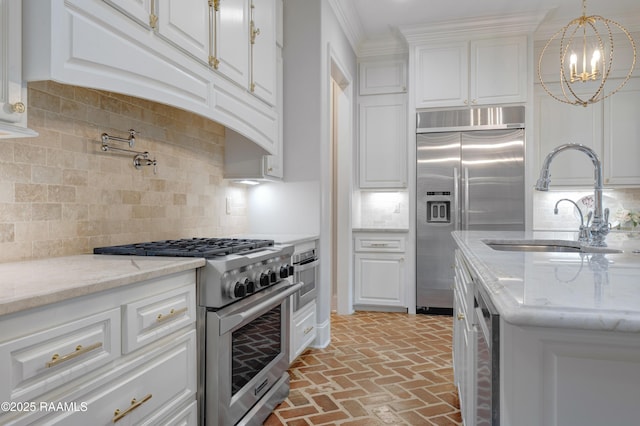506 Terrell Ct, New Iberia, LA 70563 - kitchen with premium appliances, brick flooring, white cabinets, tasteful backsplash, and crown molding
