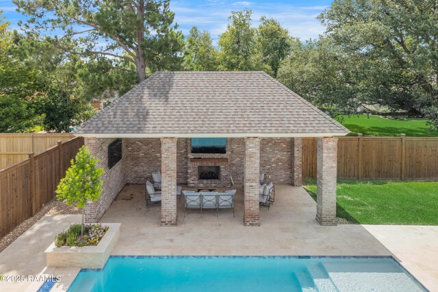 506 Terrell Ct, New Iberia, LA 70563 - view of pool with an outdoor brick fireplace, a patio area, a fenced backyard, and view of wooded area