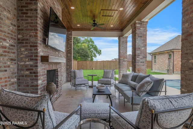 506 Terrell Ct, New Iberia, LA 70563 - fenced backyard featuring a ceiling fan, an outdoor living space with a fireplace, and a patio area