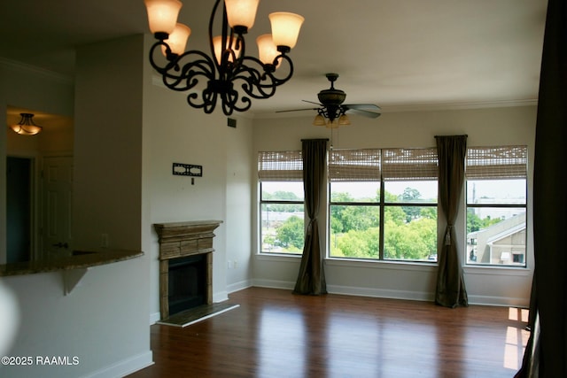 201 Settlers Trace Blvd Unit 2410, Lafayette, LA 70508 - unfurnished living room featuring ceiling fan, dark wood-style flooring, ornamental molding, a fireplace with raised hearth, and a chandelier