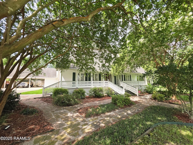 104 Running Deer Dr, Lafayette, LA 70503 - obstructed view of property featuring covered porch and stairs