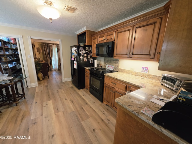 104 Running Deer Dr, Lafayette, LA 70503 - kitchen featuring black appliances, light wood-style flooring, brown cabinetry, ornamental molding, and light stone counters