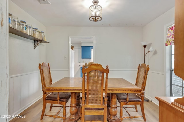 40 Hidden Hills Rd, Arnaudville, LA 70512 - dining area featuring light wood-type flooring, healthy amount of natural light, and a wainscoted wall