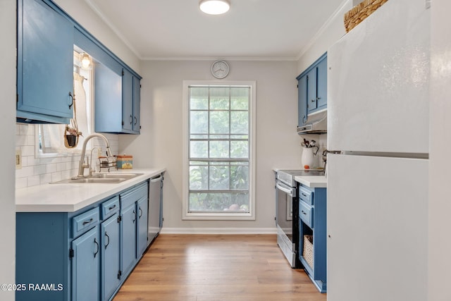 40 Hidden Hills Rd, Arnaudville, LA 70512 - kitchen with appliances with stainless steel finishes, blue cabinetry, light wood-style flooring, light countertops, and ornamental molding