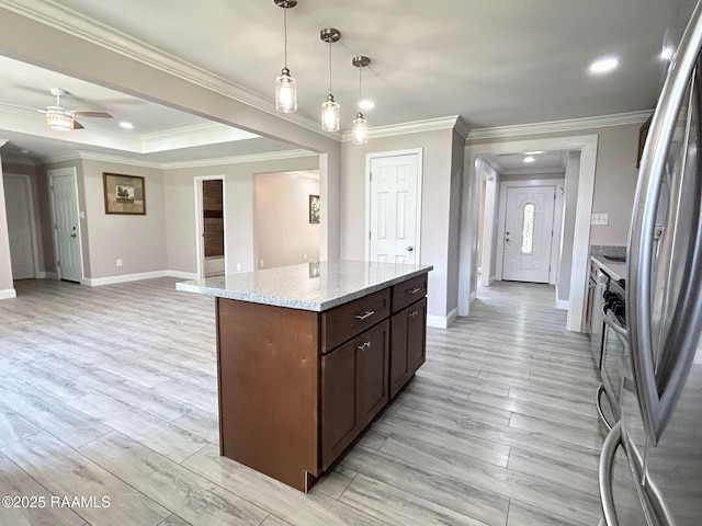 104 E Coleman St, Opelousas, LA 70570 - kitchen featuring freestanding refrigerator, ornamental molding, light wood-style floors, hanging light fixtures, and ceiling fan