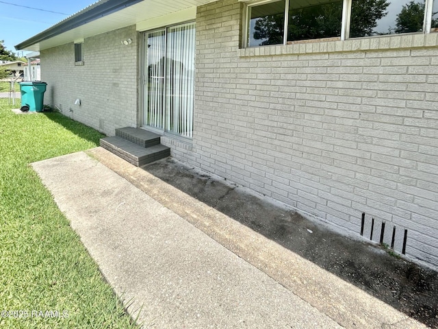 104 E Coleman St, Opelousas, LA 70570 - view of home's exterior with a lawn and brick siding