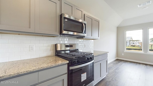 322 White Pine Dr, Lafayette, LA 70501 - kitchen featuring stainless steel appliances, gray cabinets, light stone counters, and lofted ceiling