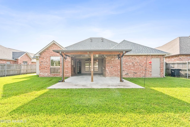 105 Clear Lake Dr, Lafayette, LA 70506 - rear view of property with a fenced backyard, a patio area, roof with shingles, and brick siding