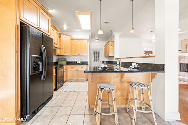 105 Clear Lake Dr, Lafayette, LA 70506 - kitchen featuring black appliances, light brown cabinetry, a peninsula, crown molding, and dark countertops