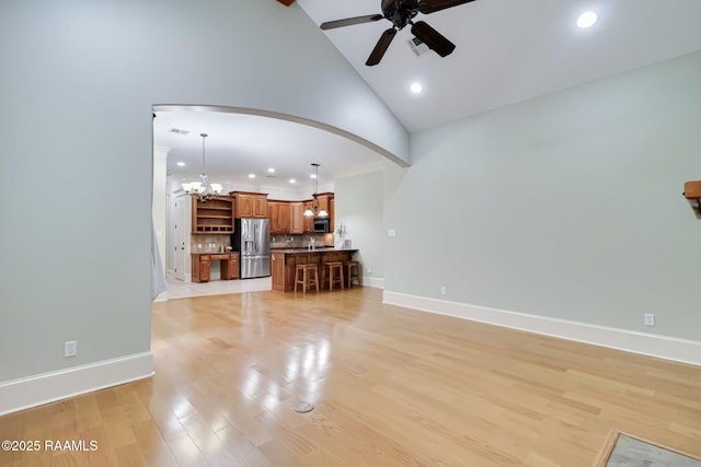 100 Serenity Sound Dr, Lafayette, LA 70506 - unfurnished living room with arched walkways, a chandelier, ceiling fan, recessed lighting, and light wood finished floors