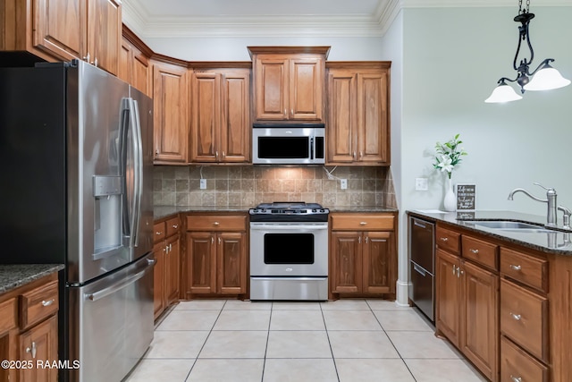 100 Serenity Sound Dr, Lafayette, LA 70506 - kitchen featuring appliances with stainless steel finishes, brown cabinets, decorative backsplash, and crown molding