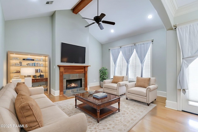 100 Serenity Sound Dr, Lafayette, LA 70506 - living area featuring beamed ceiling, a ceiling fan, wood finished floors, high vaulted ceiling, and a tile fireplace