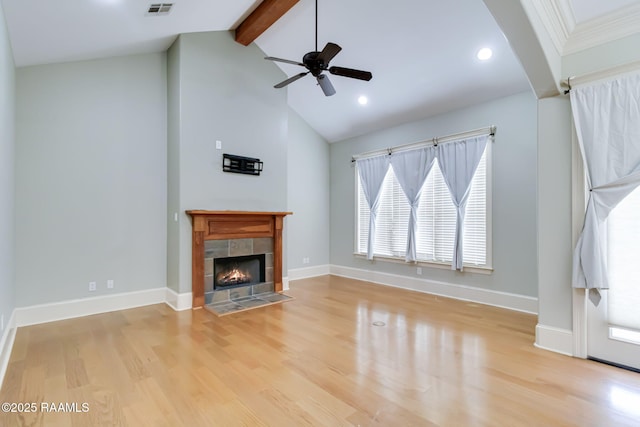 100 Serenity Sound Dr, Lafayette, LA 70506 - unfurnished living room featuring beamed ceiling, wood finished floors, plenty of natural light, a ceiling fan, and a tiled fireplace