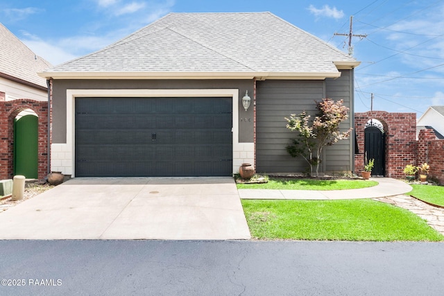 100 Serenity Sound Dr, Lafayette, LA 70506 - view of front of home with roof with shingles, a garage, and concrete driveway