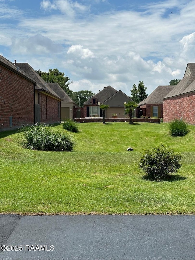 100 Serenity Sound Dr, Lafayette, LA 70506 - view of green lawn with a garage
