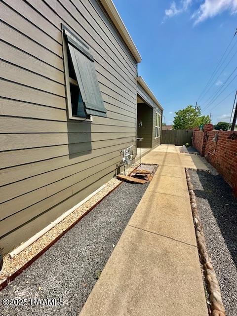 100 Serenity Sound Dr, Lafayette, LA 70506 - view of side of home with a fenced backyard and a patio area