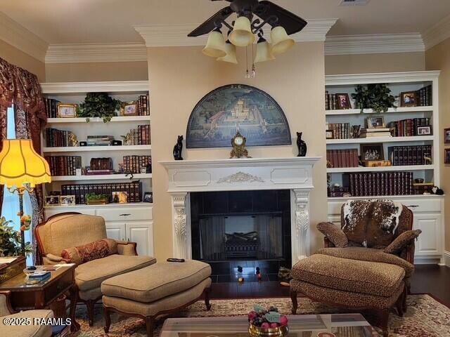 106 Princeton Woods Loop, Lafayette, LA 70508 - sitting room with crown molding, ceiling fan, wood finished floors, a fireplace with flush hearth, and built in shelves