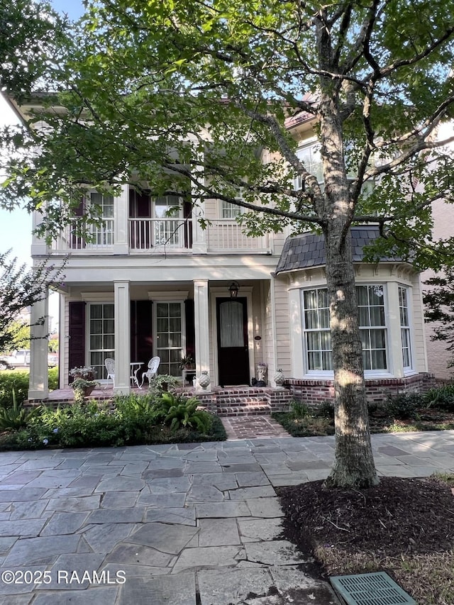 106 Princeton Woods Loop, Lafayette, LA 70508 - view of front of house with a balcony, brick siding, and a porch
