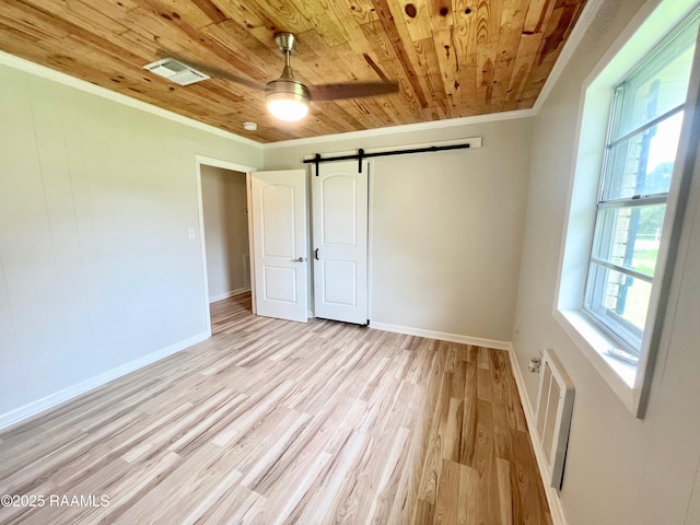 5501 Northside Rd, New Iberia, LA 70563 - unfurnished bedroom with wood ceiling, crown molding, a barn door, and light wood-type flooring