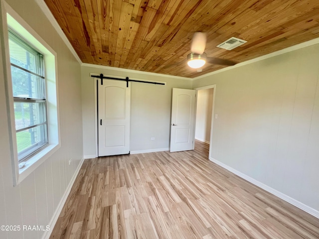 5501 Northside Rd, New Iberia, LA 70563 - unfurnished bedroom with wood ceiling, crown molding, a barn door, light wood finished floors, and a ceiling fan