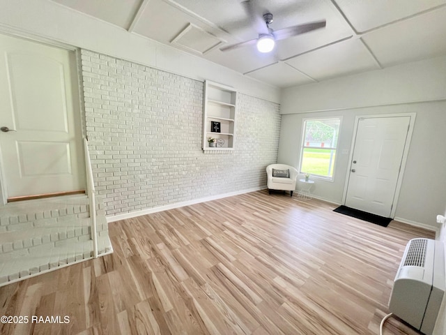 5501 Northside Rd, New Iberia, LA 70563 - entrance foyer featuring brick wall, wood finished floors, and a ceiling fan