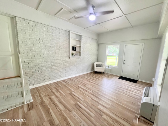 5501 Northside Rd, New Iberia, LA 70563 - entryway featuring brick wall, wood finished floors, heating unit, and a ceiling fan