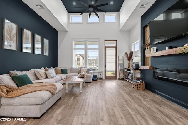 127 Lakes Edge Dr, Broussard, LA 70518 - living area with wood finished floors, a towering ceiling, and a ceiling fan