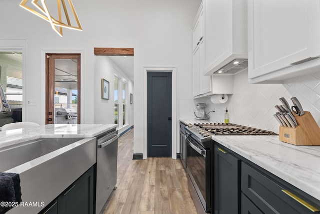 127 Lakes Edge Dr, Broussard, LA 70518 - kitchen featuring appliances with stainless steel finishes, custom exhaust hood, white cabinets, and decorative backsplash