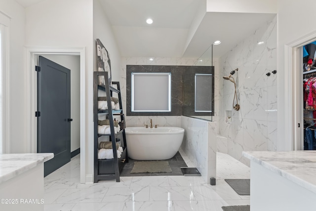 127 Lakes Edge Dr, Broussard, LA 70518 - bathroom with a soaking tub, a marble finish shower, marble finish floors, a spacious closet, and recessed lighting