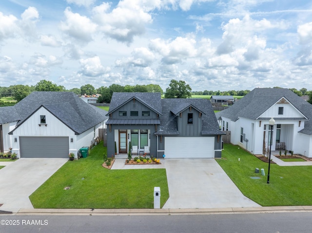 127 Lakes Edge Dr, Broussard, LA 70518 - modern inspired farmhouse featuring concrete driveway, roof with shingles, board and batten siding, a standing seam roof, and a front lawn