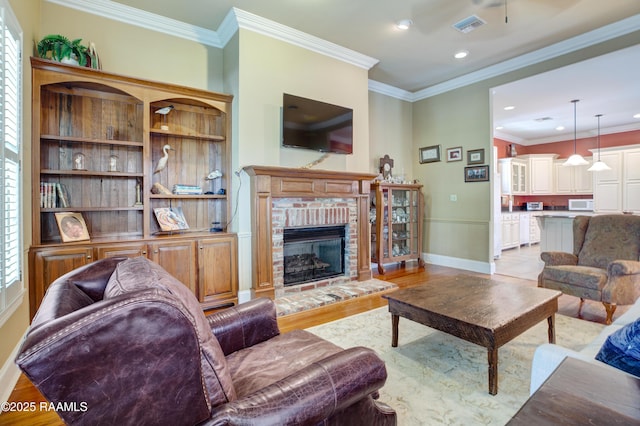 302 River Ranch Blvd, Lafayette, LA 70508 - living room featuring light wood-style flooring, a brick fireplace, ornamental molding, and recessed lighting