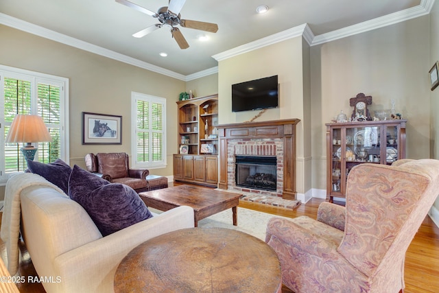 302 River Ranch Blvd, Lafayette, LA 70508 - living area with wood finished floors, a fireplace, a ceiling fan, crown molding, and recessed lighting