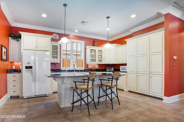 302 River Ranch Blvd, Lafayette, LA 70508 - kitchen featuring white appliances, a kitchen breakfast bar, glass insert cabinets, dark countertops, and white cabinets