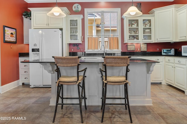 302 River Ranch Blvd, Lafayette, LA 70508 - kitchen with dark countertops, glass insert cabinets, and white cabinetry