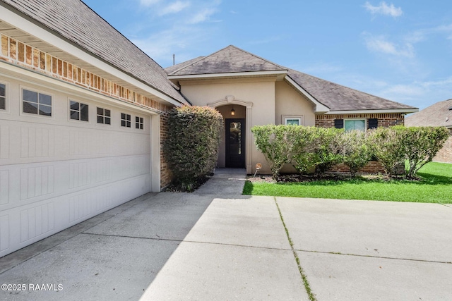 213 Hidden Ridge Dr, Lafayette, LA 70507 - view of front of home featuring concrete driveway, a garage, roof with shingles, and stucco siding