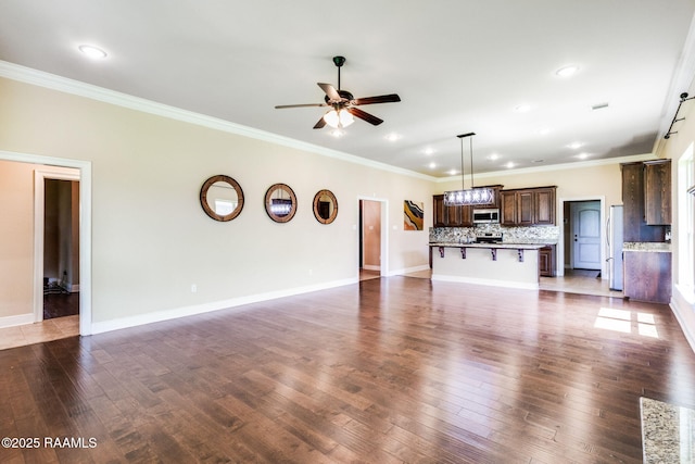 213 Hidden Ridge Dr, Lafayette, LA 70507 - unfurnished living room featuring a ceiling fan, crown molding, recessed lighting, and dark wood-type flooring