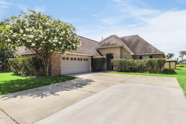 213 Hidden Ridge Dr, Lafayette, LA 70507 - view of front of house featuring driveway, brick siding, a front yard, and an attached garage