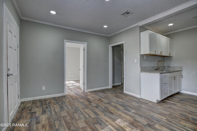 807/809 E Vermilion St, Abbeville, LA 70510 - kitchen featuring white cabinetry, dark wood-style flooring, a textured ceiling, light stone countertops, and recessed lighting