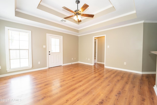 1518 S Patout St, New Iberia, LA 70560 - empty room with a raised ceiling, a ceiling fan, light wood finished floors, and crown molding