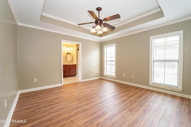 1518 S Patout St, New Iberia, LA 70560 - empty room with a raised ceiling, light wood-style flooring, ceiling fan, and ornamental molding