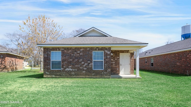 1005 W End Dr, New Iberia, LA 70560 - back of property with a yard, roof with shingles, and brick siding